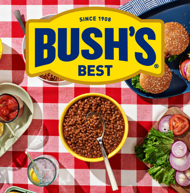 Bush's logo on top of a table cloth with beans and other foods.