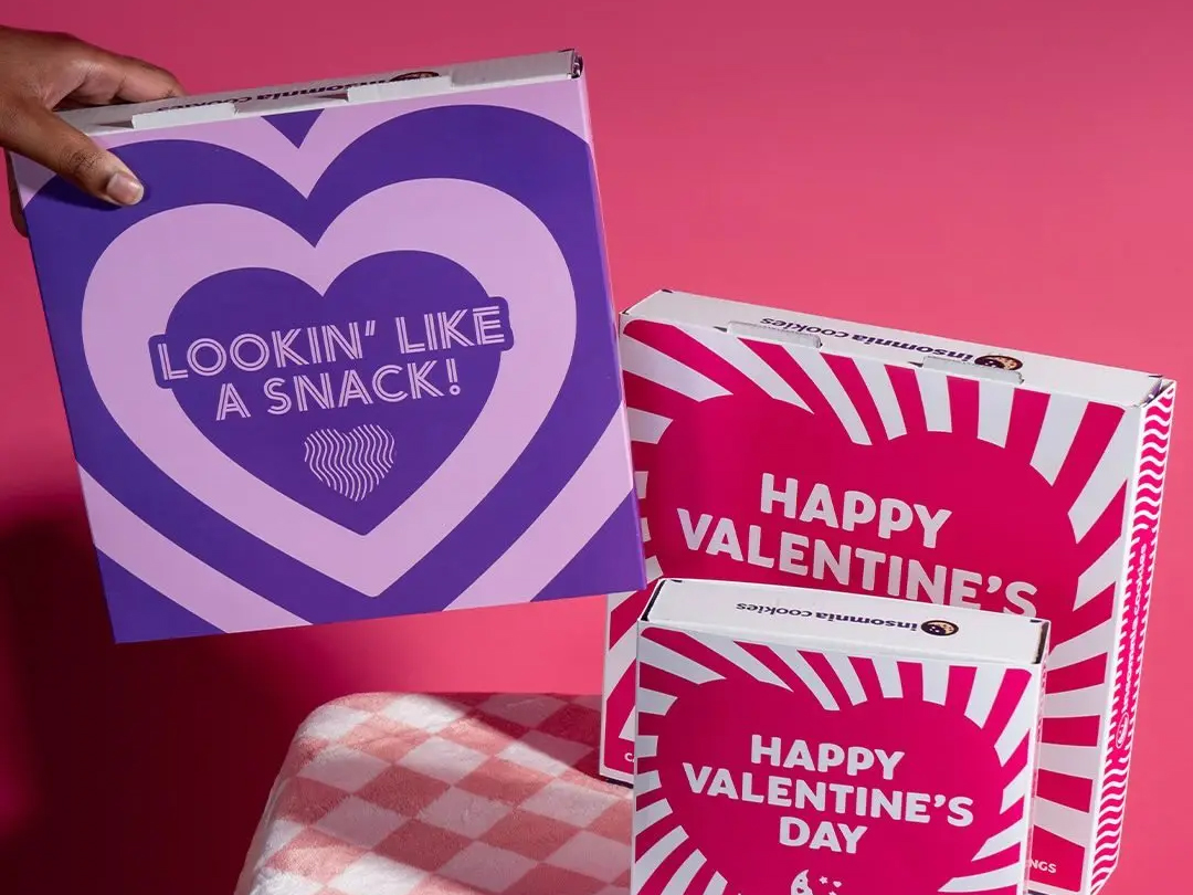 Three Insomnia Cookie boxes on display.