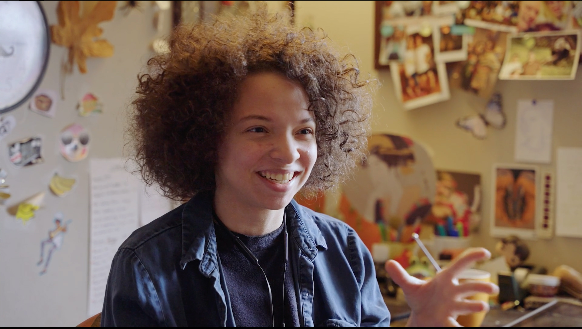 A child smiling in their bedroom.